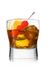 Old fashioned cocktail with cherries on still pick and orange slice on white background Royalty Free Stock Photo