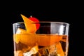 Old fashioned cocktail with orange and cherry on black background. Royalty Free Stock Photo