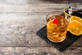 Old fashioned cocktail with orange and cherry on wooden table Royalty Free Stock Photo