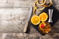 Old fashioned cocktail with orange and cherry on wooden table Royalty Free Stock Photo