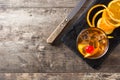 Old fashioned cocktail with orange and cherry on wooden table Royalty Free Stock Photo