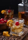 Old fashioned cocktail with orange peel and cherry Royalty Free Stock Photo