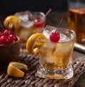 Old fashioned cocktail with orange peel and cherry Royalty Free Stock Photo