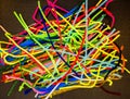 Colorful pipe cleaners against black background