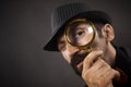 Detective with loupe