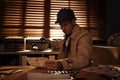 Old fashioned detective working at table in office Royalty Free Stock Photo