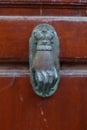 Old fashioned door knocker on the brown wooden door, Hydra Island, Greece