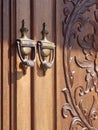 Old fashioned door knocker with carved door Royalty Free Stock Photo
