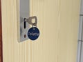 Old-fashioned door lock with a key, a round blue key plate with the inscription "toilets" Royalty Free Stock Photo