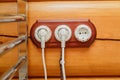 Old fashioned electricity switches, socket, electric wire in on a wooden wall.