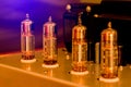 Old-fashioned electronic device amplifier with glowing bulb diode lamp for sound reproduction