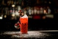 Old-fashioned glass with cold red drink decorated with Christmas tree toy and chocolate candy man Royalty Free Stock Photo