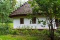 Old fashioned house with a thick thatched roof in Ukraine