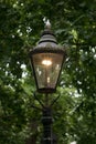 Old fashioned iron street lamp on The Mall in central London, lit up at dusk Royalty Free Stock Photo