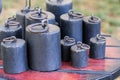 Old-fashioned iron weights on a wooden tray of an old scale Royalty Free Stock Photo