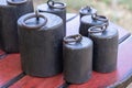 Old-fashioned iron weights on a wooden tray of an old scale Royalty Free Stock Photo