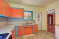 Old fashioned kitchen interior with orange and blue cabinets. Royalty Free Stock Photo
