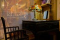 Old-fashioned lamp and aged wooden table and chair in bookstore