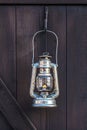 Old fashioned lantern on a brown wooden wall Royalty Free Stock Photo