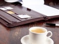 Old fashioned leather folder with coffee