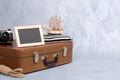 Old fashioned leather suitcase, picture frame with blank black space for text, sailboat toy, retro photo camera, rope. Royalty Free Stock Photo