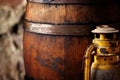 Old fashioned light kerosene lantern style oil lamp and barrels.closeup Royalty Free Stock Photo
