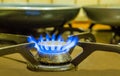 Old fashioned lighted gas cooker, burning blue flames, retro kitchen equipment Royalty Free Stock Photo