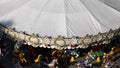 Old fashioned merry-go-round fairground attraction with horses, cart and a sledge.