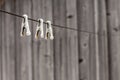 Old-fashioned metal clothespins hanging on the clothesline rope