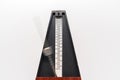 Old fashioned metronome with blurred arm indicating motion isolated on a white background Royalty Free Stock Photo