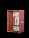 An old fashioned metronome ,made from wood box, black background, Selective focus Royalty Free Stock Photo