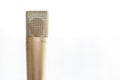 An old fashioned microphone in front of a white background