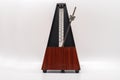 Old fashioned musical metronome isolated on a white background