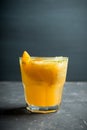 Old fashioned orange cocktail on rustic background