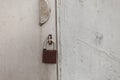 Old fashioned padlock on light grey steel door Royalty Free Stock Photo