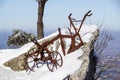 Old fashioned plough in the snow .old antique harrow at a field Royalty Free Stock Photo