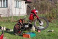 Old-fashioned red motorcycle during maintenance. Jawa motorbike in whole parade. Renovation retro bike after long winters in Royalty Free Stock Photo