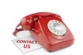 Old fashioned red telephone with contact us messag