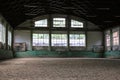 Old fashioned riding hall with sandy covering without people