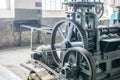 Old-fashioned rolling mill machine in historical factory. Original equipment from the beginning of the XX century. Big gear, rolls