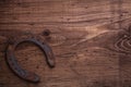 Old fashioned rusted horseshoe on vintage wooden