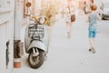 Old fashioned scooter parked on the sidewalk Royalty Free Stock Photo