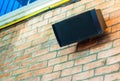 Old-fashioned speakers mounted on a brick wall