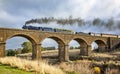 Old Fashioned Steam Train Crossing a Historic Bluestone Masonry Bridge, Malmsbury, Victoria, Australia, June 2019