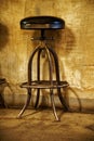 Old fashioned steel chair on wooden floor at concrete wall Royalty Free Stock Photo