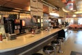 Long counter top with old-fashioned stools inside popular restaurant, Rochester, New York, 2017