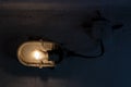 Old fashioned storage or factory lamp covered in spider`s web