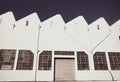 Old-fashioned storage industrial building with closed roller door