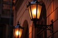 Old fashioned street lamp at night. Brightly lit street lamps at sunset. Decorative lamps. Magic lamp with a warm yellow light in Royalty Free Stock Photo