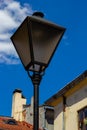 Old-fashioned street wall lamp made of black metal. Gray facade of an old house. Lviv, Ukraine Royalty Free Stock Photo